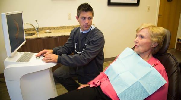 Dr. Justin Newingham of Newingham Dental Center in Birmingham, MI meets with a patient.