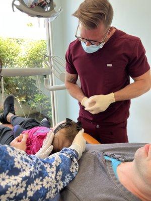 Dr. Higgins and Angie talking with our daughter Ariela before her first cleaning =)