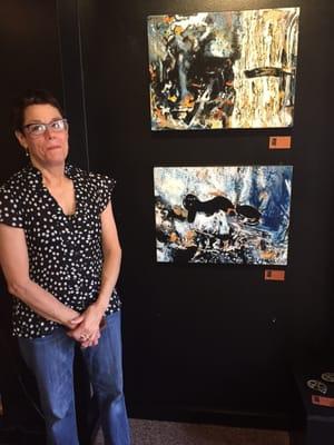 Laura Hanan and two of her edgy paintings.