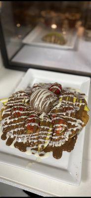 Fried banana pancake topped with a fruits and ice cream