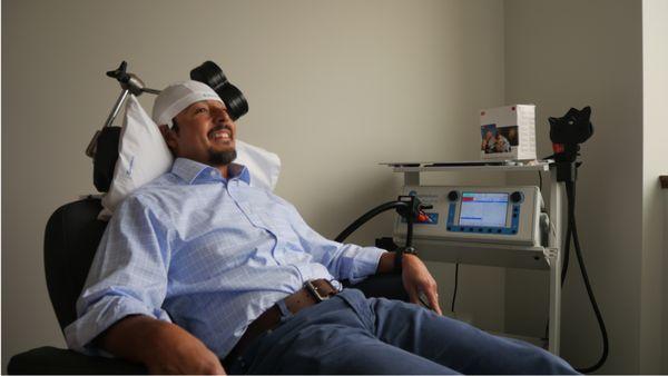 Man sitting in a Magventure TMS Treatment Chair.