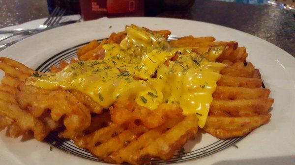 Waffle fries with cheese.