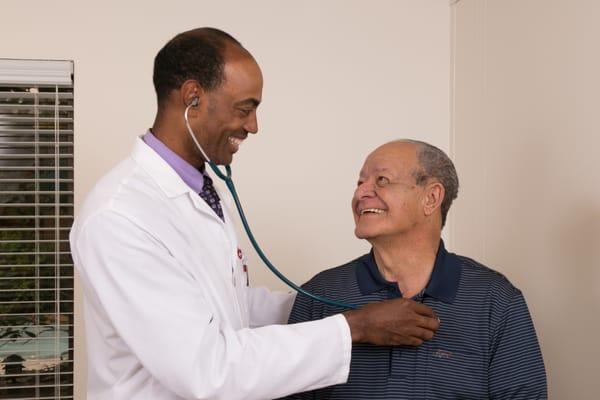 One of our knowledgeable and caring doctors with a happy patient.