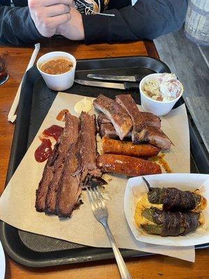 3 Meat Plate with brisket, black & bleu sausage, ribs, jalepeño poppers, Hawaiian baked beans, and gorgonzola potato salad