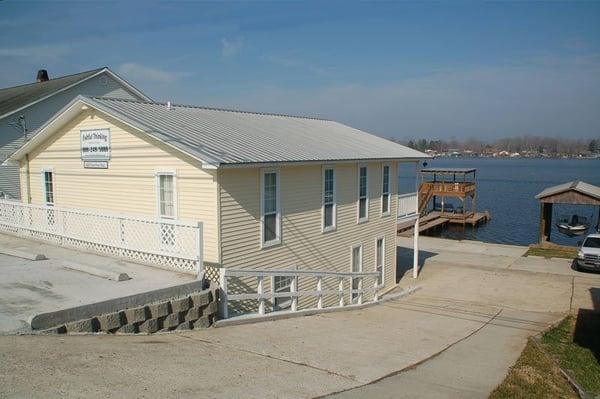 View of cottage and lake