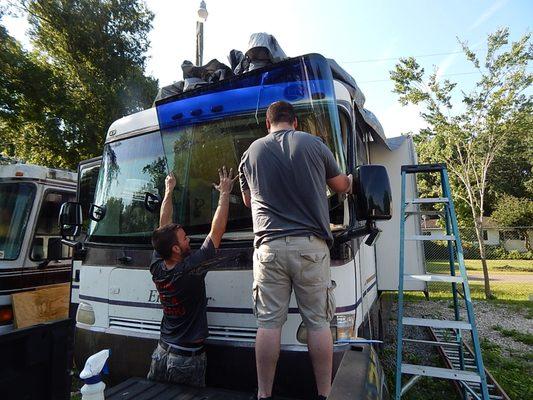 The only real way to stop leaks on windshield is to level RV, remove and reinstall