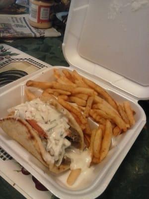 Chicago beef gyro with cucumber sauce and fries.