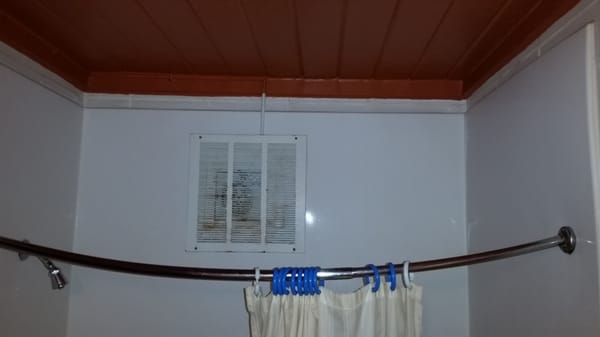 Shower Curtain rod hangs sadly.