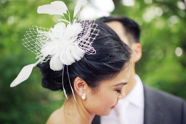 Elegant wedding hair for the lovely bride.. we add a touch of feathers for a complete look.