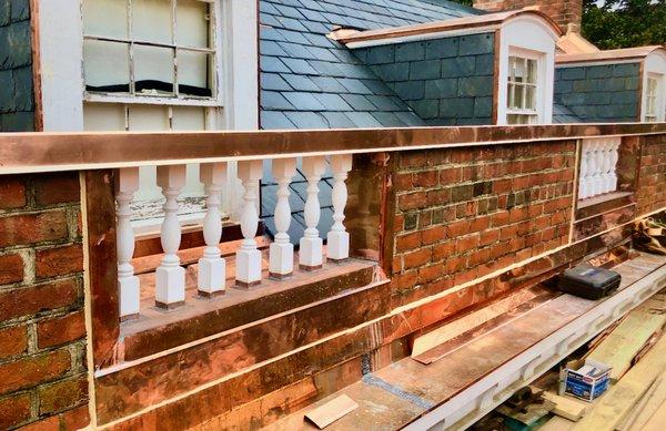 Historic copper roof restoration with a new baluster, while reusing the existing slate.