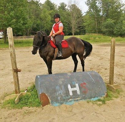 Rider in front of NHS jump.