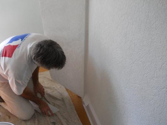 Installation of a textured wall covering over plaster walls that were in rough shape.  This wall covering is designed to hide...