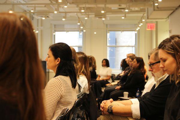 Elysia leading a corporate group Mindfulness meditation.