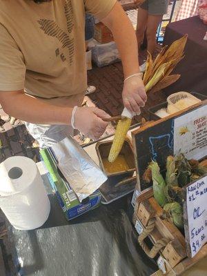 Butter brushing the corn