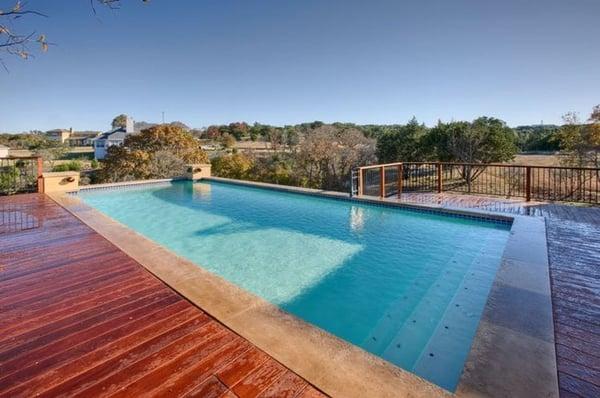 Modern style geometric pool with wood decking.