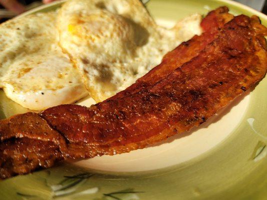 Over easy eggs with crispy bacon