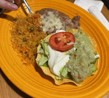 Plate of rice and beans, sour cream and guacamole.