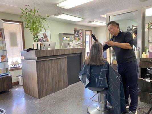 Johnny styling customer's hair