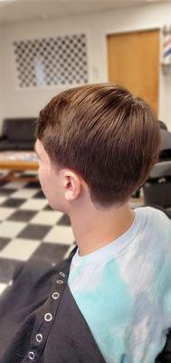 Classic haircut with barber taper back and sides