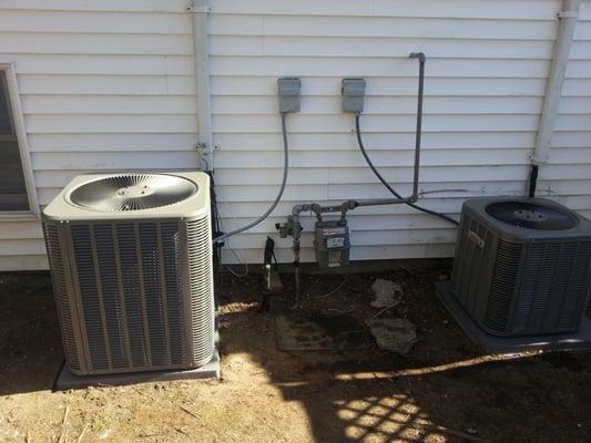 Picture shows new units installed as per code that allows for the proper servicing of the gas meter and AC equipment.