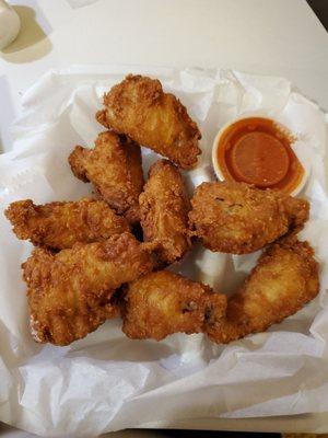 Fried wings with a side of buffalo sauce