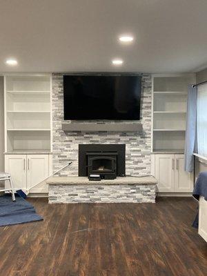 Full fireplace renovation. New hearth, built ins, mantle, electrical and TV mount