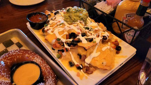 Happy hour nachos $11 made with beer cheese, add guacamole +$3 - recommend