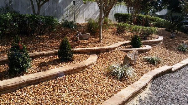 Yard on a hill and incline and tired of mulch and dirt running down after hard rains?? Call us to install retaining wall stones w/ caps