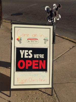 The "we're open" signage