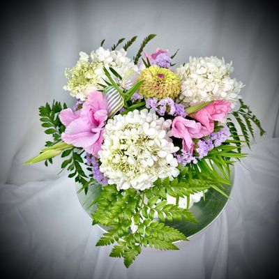 Fluffy white Hydrangeas, pink Gladiolas, snd lime Zinnia create a beautiful floral collage.