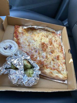 2 slices of cheese pizza with garlic knots and ranch dressing