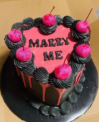 This is a heart-shaped cream cheese icing carrot cake with sparkly cherries