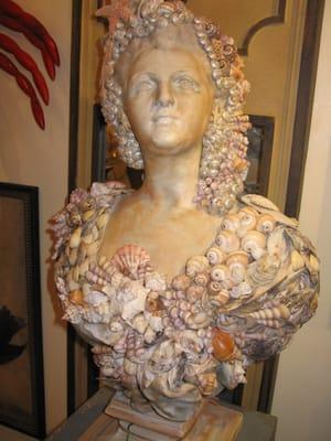 A seashell encrusted bust.