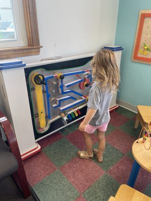 My daughter playing with all the fun toys in the waiting room!