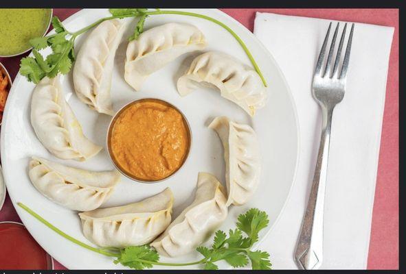 Lumbini fusion chicken juicy Momos are a type of steamed filled dumpling. Momos are usually served with a sauce.