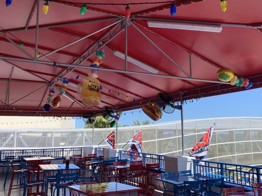 A beautiful patio area with a view of the beach.