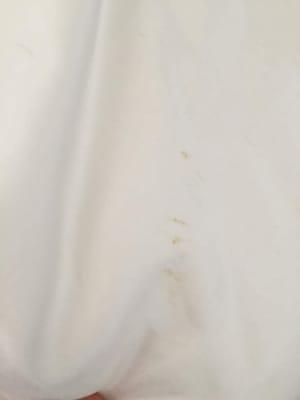 Brand new satin white blanket dropped off for cleaning and was returned with stains and loose thread.