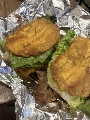 Jibarito (sandwich with 2 fried plantains, lettuce, tomato, onions, and special sauce)