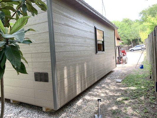 Side and back with custom horizontal siding, window (without muntins), and low vents