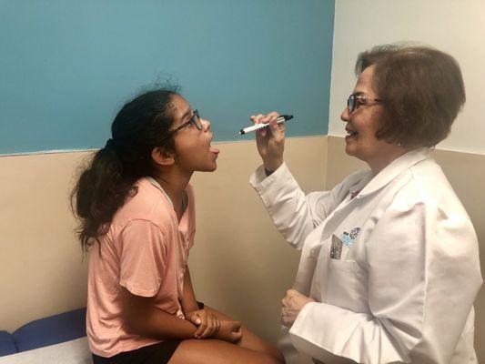 Doctor Norma B. Cornejo examining a young patient.