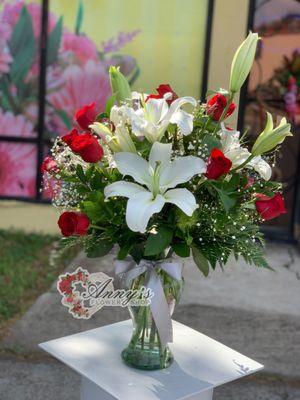 Arrangement with a dozen roses and lilies.