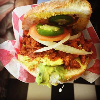 Meet our "Maton" best Lonche (Torta or Sandwich) of our marinated pork, fresh avocado, tomato,onion and Serrano or Jalapeño.