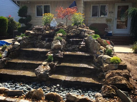 A waterfall designed by Yard Smart Lawn Care Inc