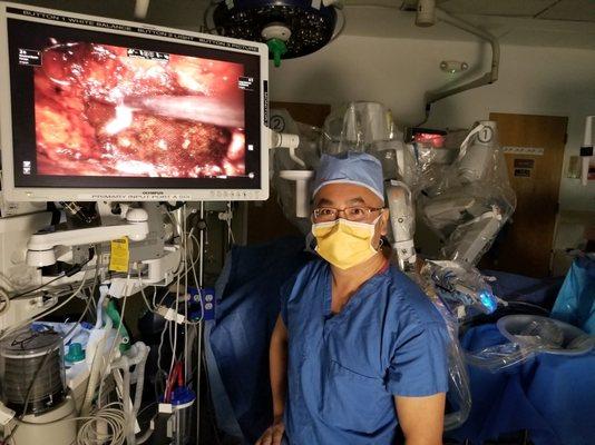 Dr. Nguyen during a procedure, controlling a robot to make smaller incisions, resulting in less pain and faster recovery.