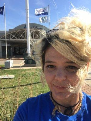 Julie Fletcher and the front of The Colony Public Library