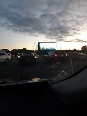 Notice the two cars on the left have to awkwardly angle their cars to get a view of the small screen that's not even centered