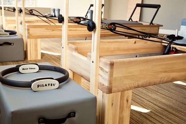 Our pilates reformer room showcasing our reformers with a pilates ring in the foreground.