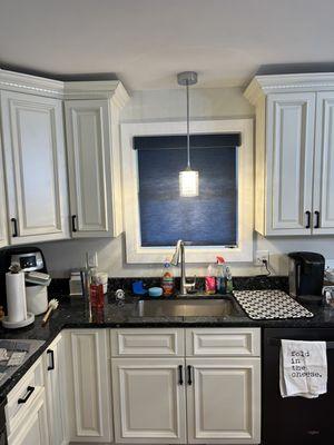 This simple roller shade in the kitchen window picked up the blue in the counter top and added a great pop of color!!