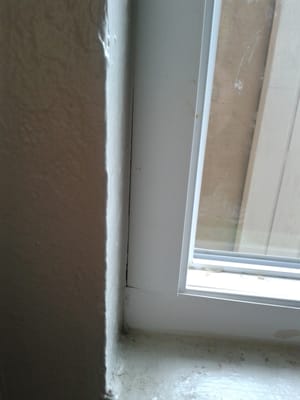 Cracks and super glued window in a second story apartment