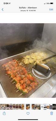 Chicken kabobs being  cooked